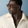 This off-white polo sweater features an open V-neck with a spread collar and no button placket, knitted in a soft, fluffy bouclé texture with long sleeves and a relaxed silhouette.